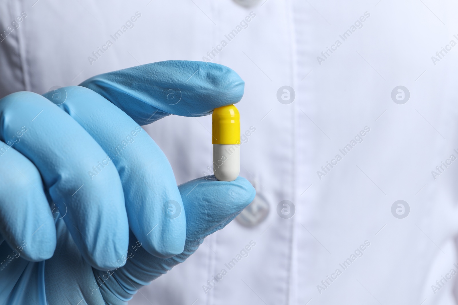 Photo of Doctor holding pill, closeup. Space for text