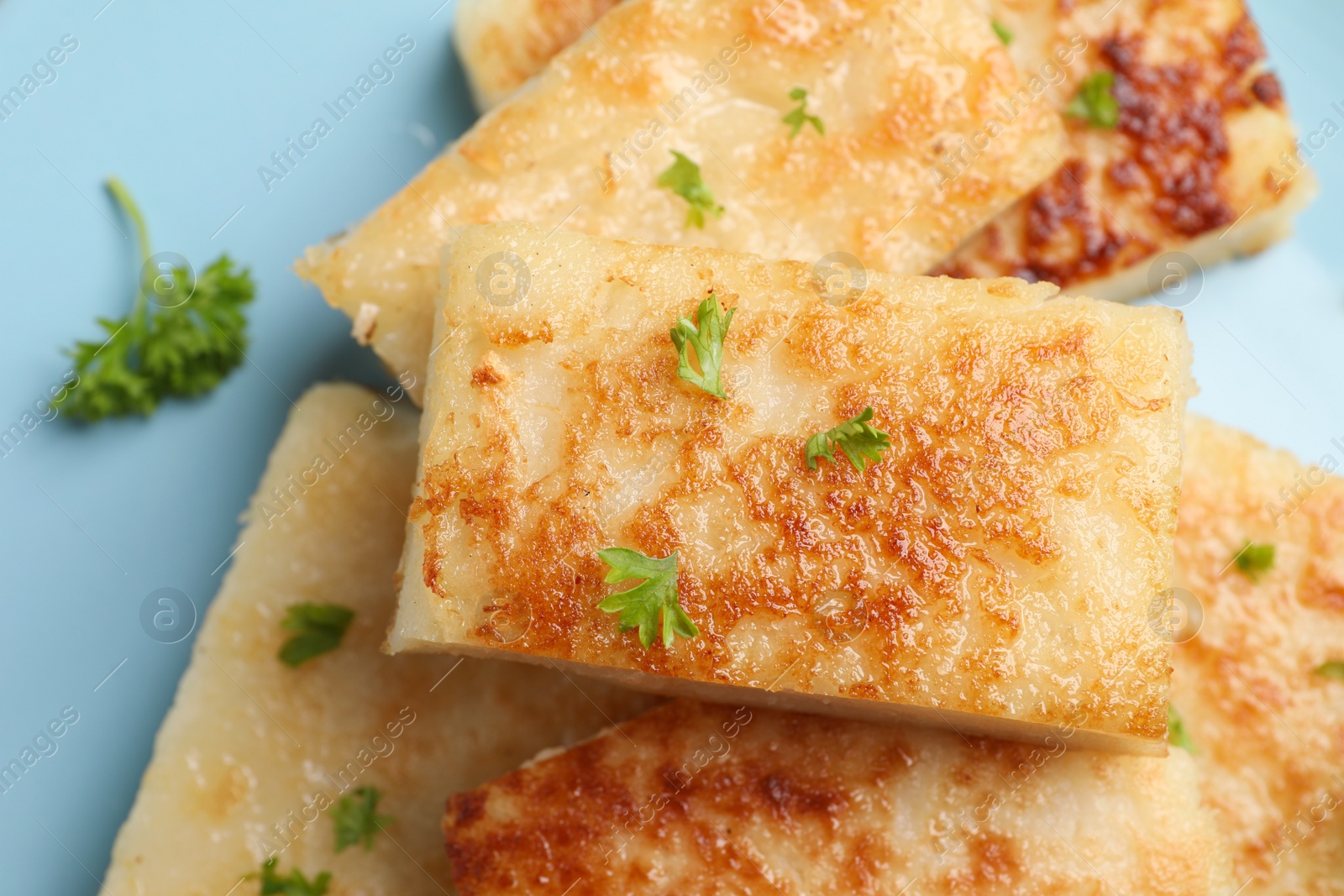 Photo of Delicious turnip cake with parsley on plate, closeup