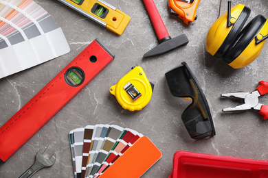 Flat lay composition with different construction tools on grey marble background