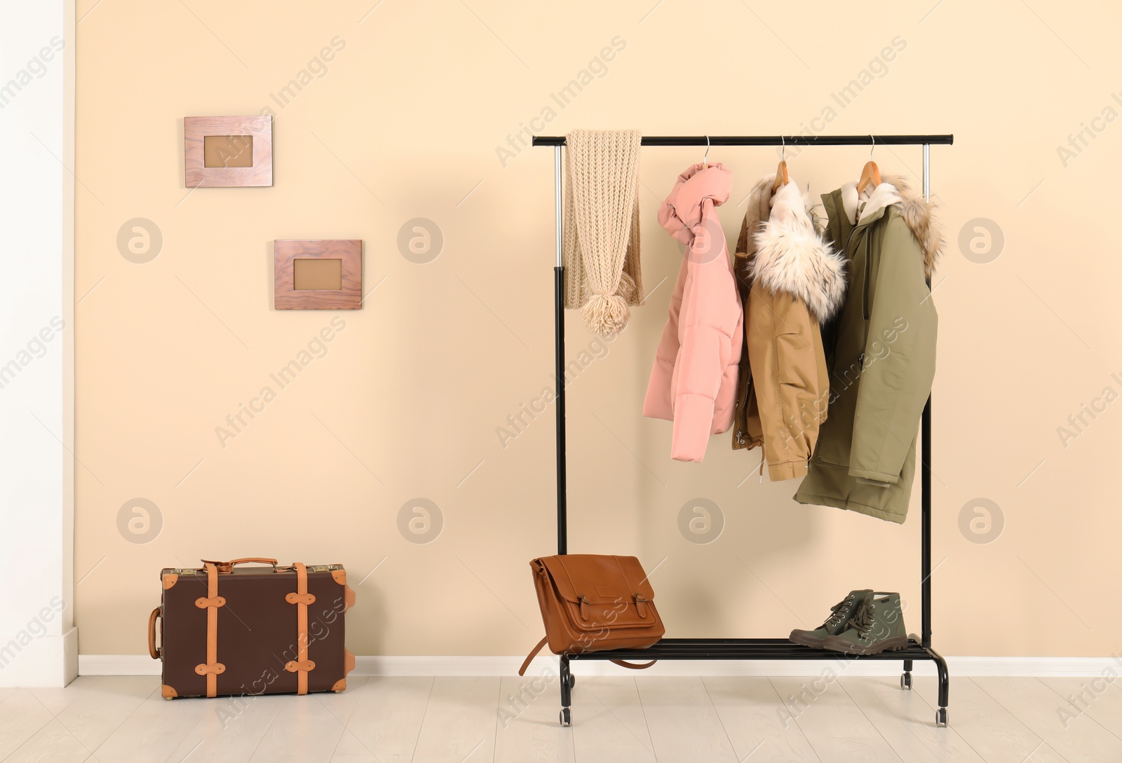 Photo of Stylish hallway interior with clothes on hanger stand