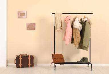 Stylish hallway interior with clothes on hanger stand