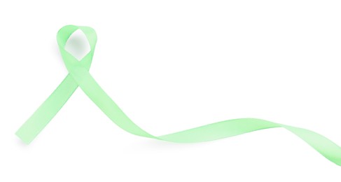 Photo of Light green awareness ribbon isolated on white, top view