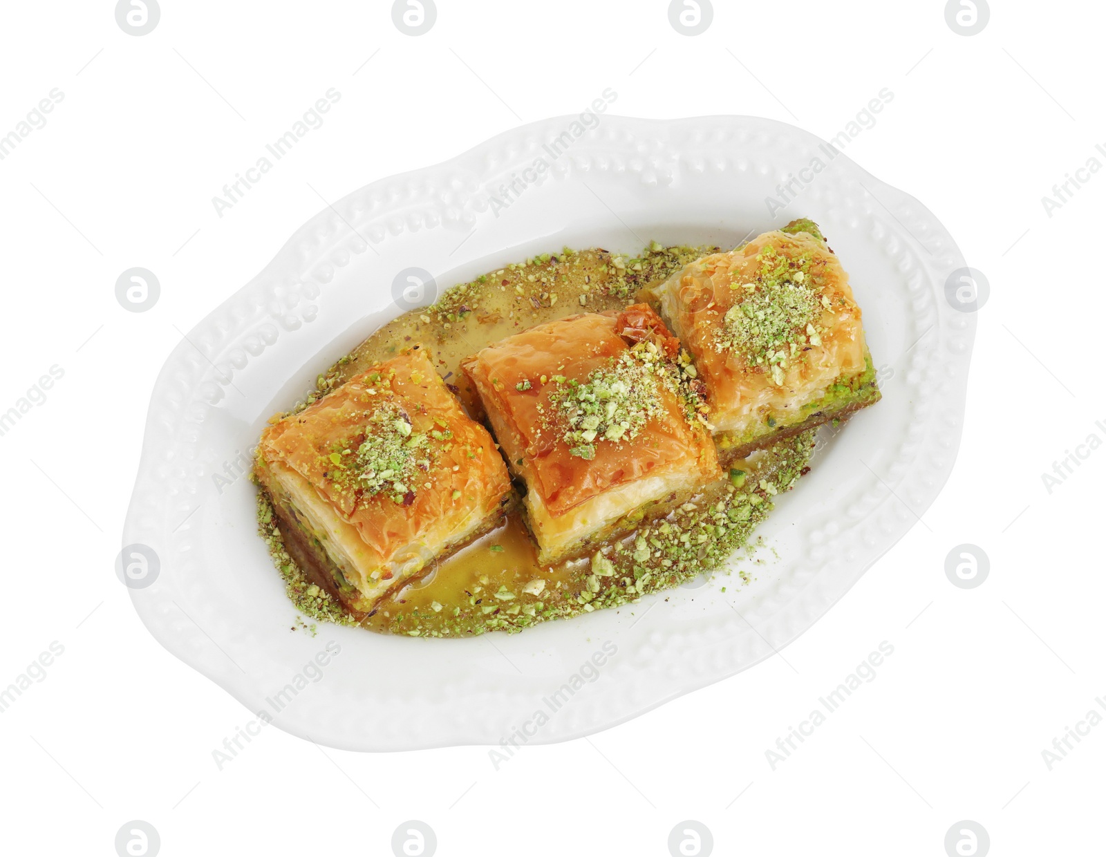 Photo of Delicious fresh baklava with chopped nuts and honey isolated on white, top view. Eastern sweets