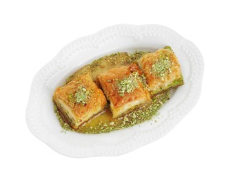 Delicious fresh baklava with chopped nuts and honey isolated on white, top view. Eastern sweets