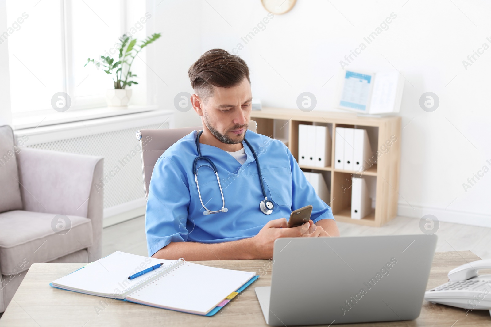 Photo of Male medical assistant at workplace in clinic. Health care service