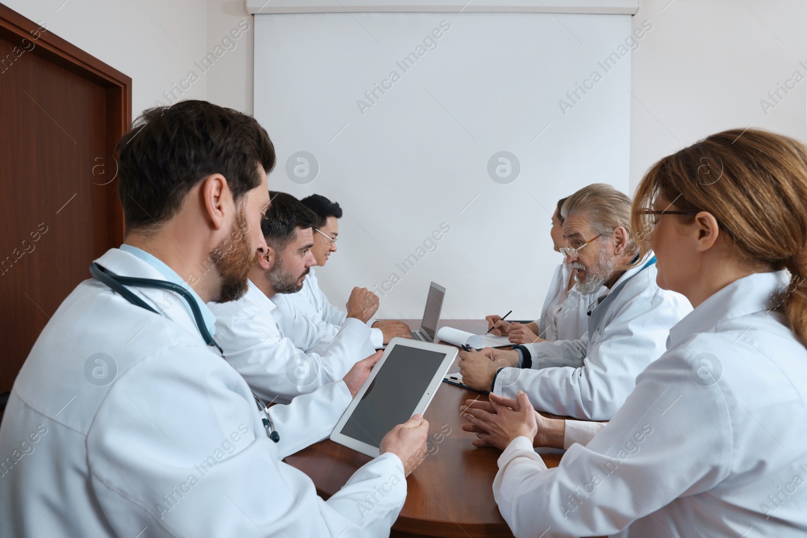 Photo of Team of doctors having discussion during medical conference in meeting room