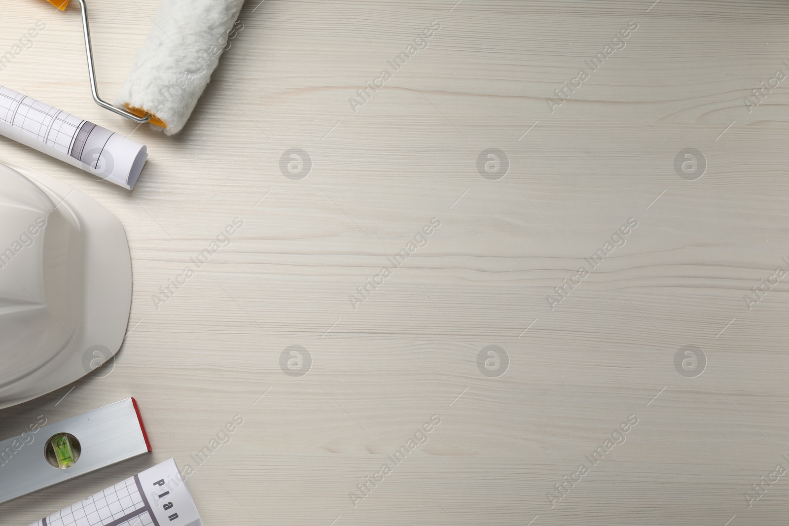 Photo of Flat lay composition with building level and other construction tools on white wooden table, space for text