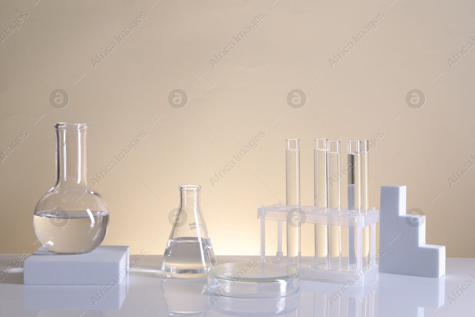 Photo of Laboratory analysis. Different glassware on table against beige background