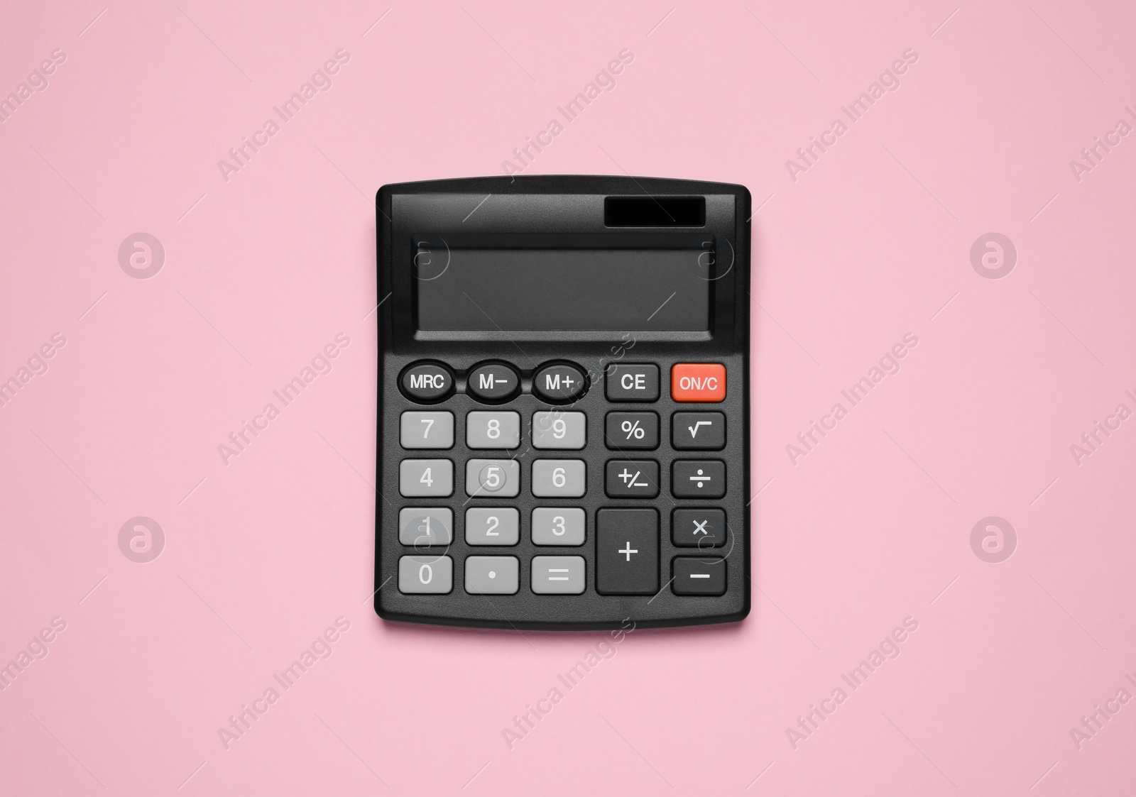 Photo of Calculator on pink background, top view. Office equipment