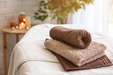 Photo of Towels on massage table in spa salon