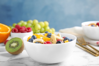 Photo of Fresh tasty fruit salad on white marble table