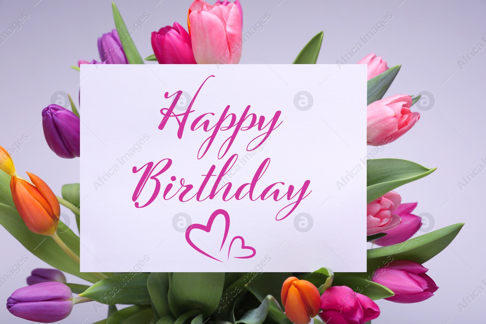 Image of Beautiful bouquet of tulip flowers with Happy Birthday card on light background, closeup