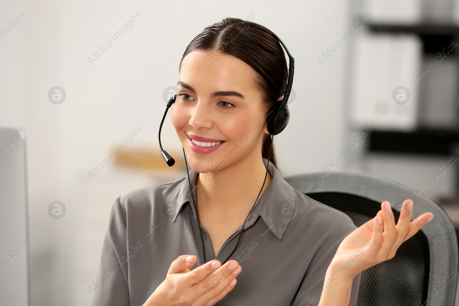 Photo of Hotline operator with headset working in office