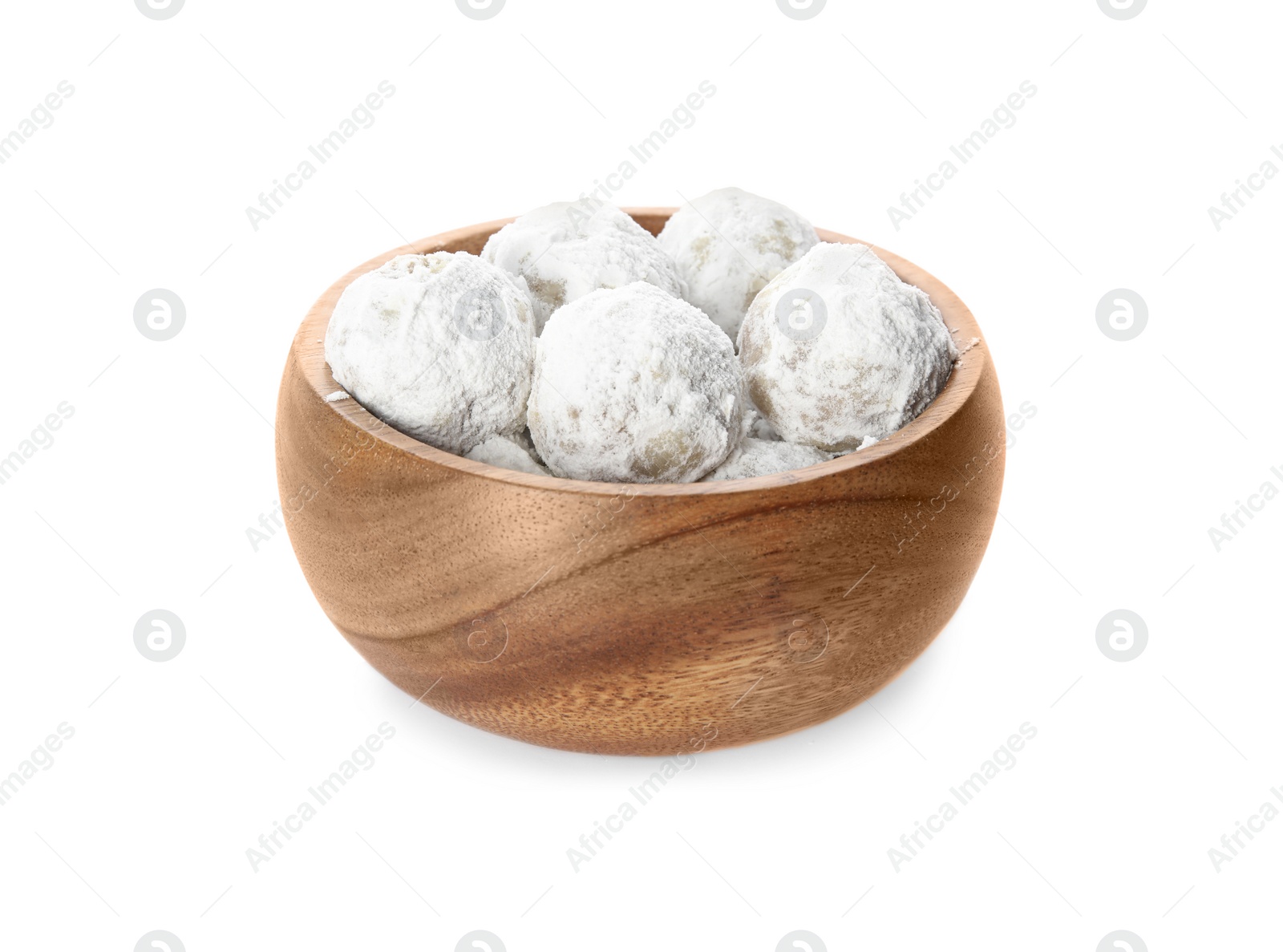 Photo of Wooden bowl full of tasty Christmas snowball cookies isolated on white