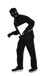 Thief in balaclava sneaking with laptop on white background