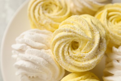 Photo of Delicious yellow and white marshmallows on plate, closeup