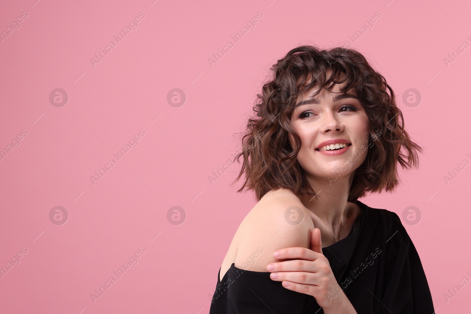 Photo of Portrait of beautiful young woman with wavy hairstyle on pink background. Space for text