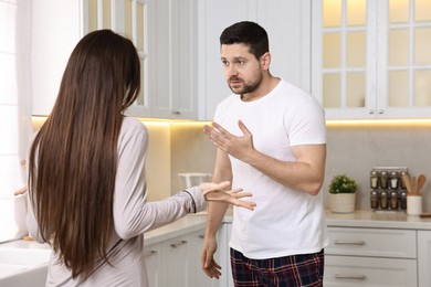 Emotional couple arguing in kitchen. Relationship problems