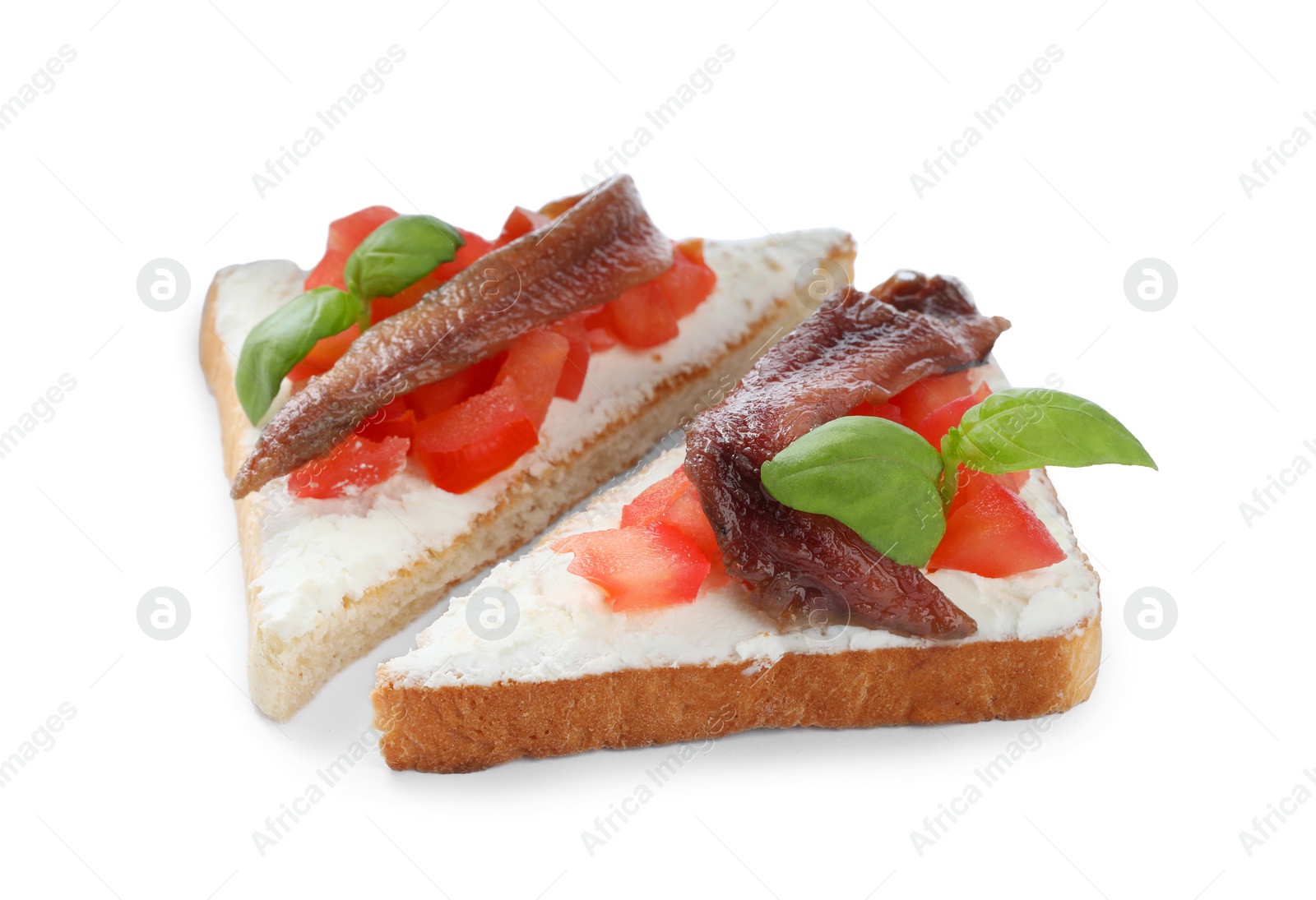 Photo of Delicious sandwiches with cream cheese, anchovies, tomatoes and basil on white background