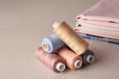 Photo of Set of color sewing threads on light grey table