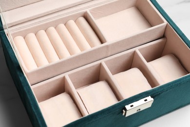 Photo of Stylish empty jewelry box on white table, closeup