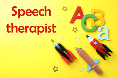 Image of Bright toy rockets and school supplies and text Speech Therapist on yellow background, flat lay 