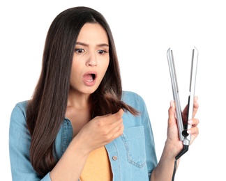 Photo of Upset woman with hair iron on white background