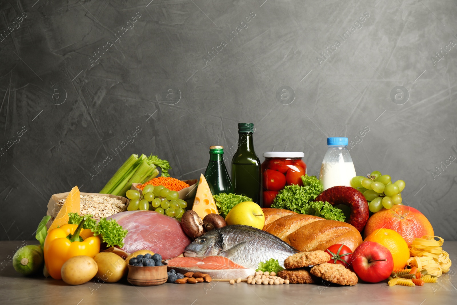 Photo of Different products on grey table. Healthy food and balanced diet