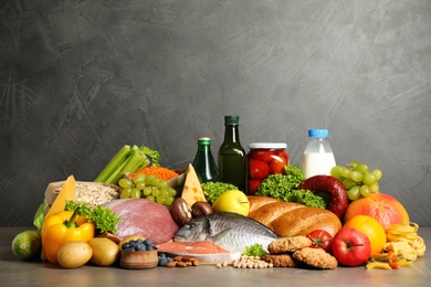 Photo of Different products on grey table. Healthy food and balanced diet