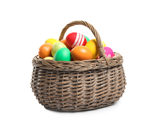 Photo of Bright Easter eggs in wicker basket isolated on white background