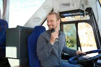 Photo of Professional driver making announcement for passengers in bus