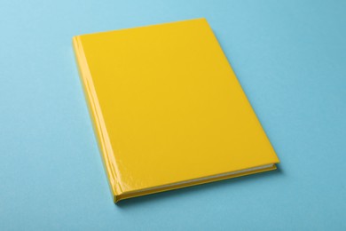 New yellow planner on light blue background