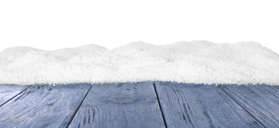 Photo of Heap of snow on blue wooden surface against white background