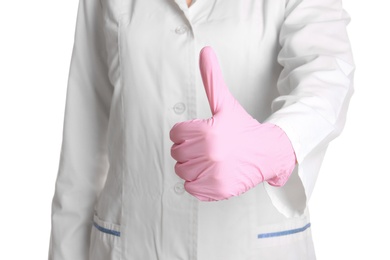 Photo of Doctor in medical glove showing thumb-up gesture on white background