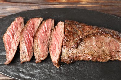 Photo of Pieces of delicious grilled beef meat on table, closeup