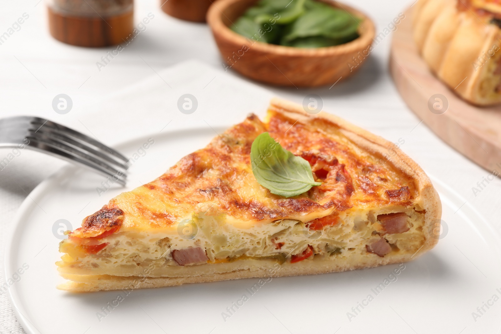 Photo of Delicious homemade vegetable quiche on plate, closeup