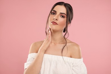 Photo of Beautiful woman with elegant necklace on pink background