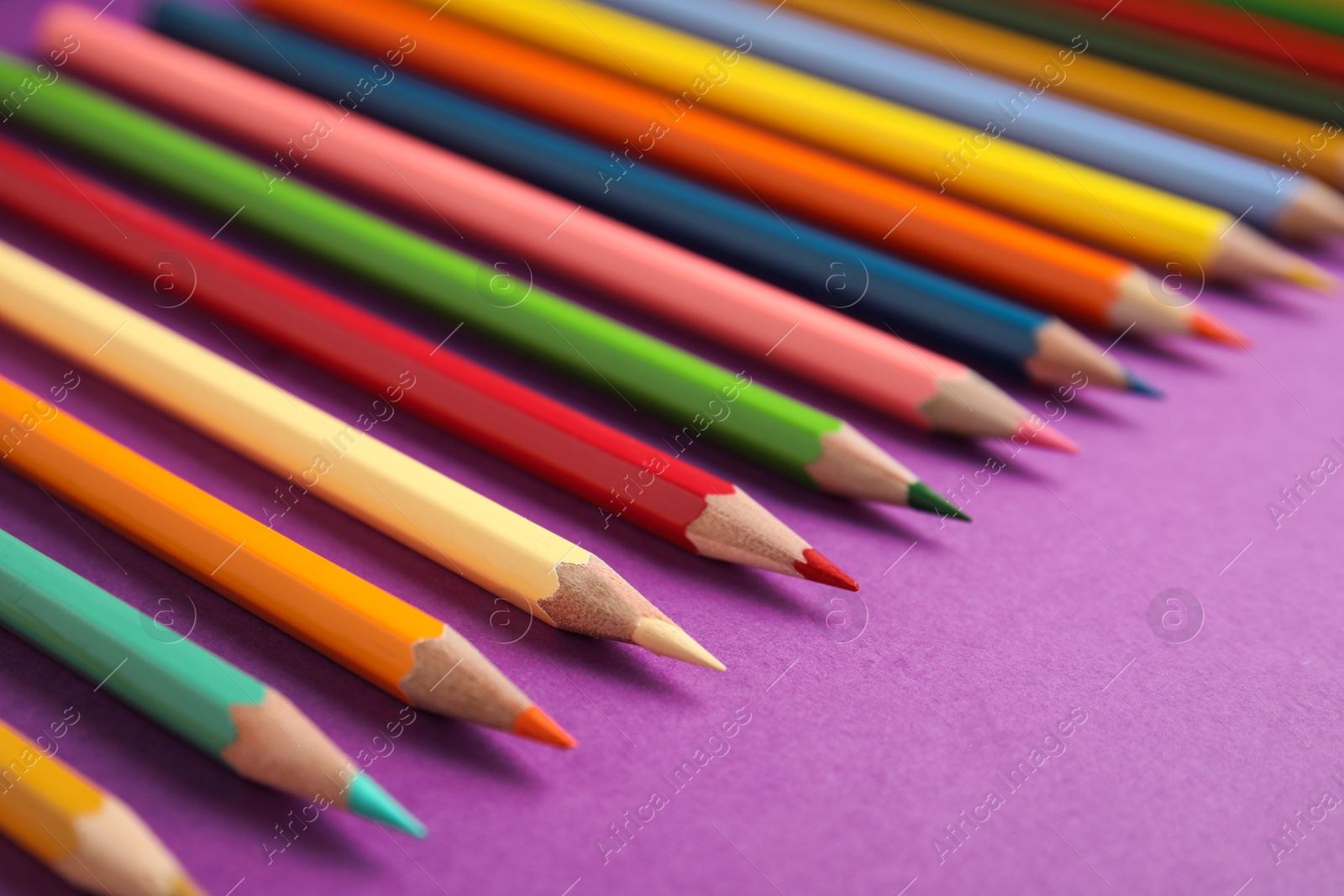 Photo of Composition with color pencils on purple background