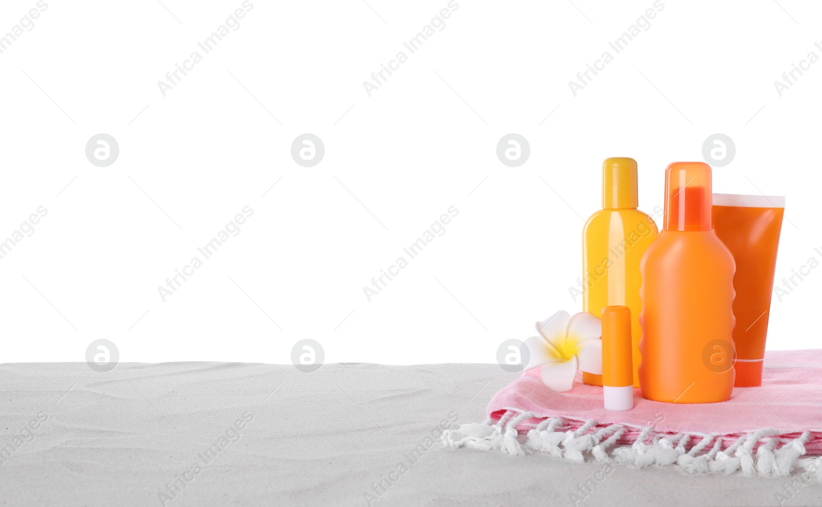 Photo of Sun protection cosmetic products and beach accessories on sand. Space for text