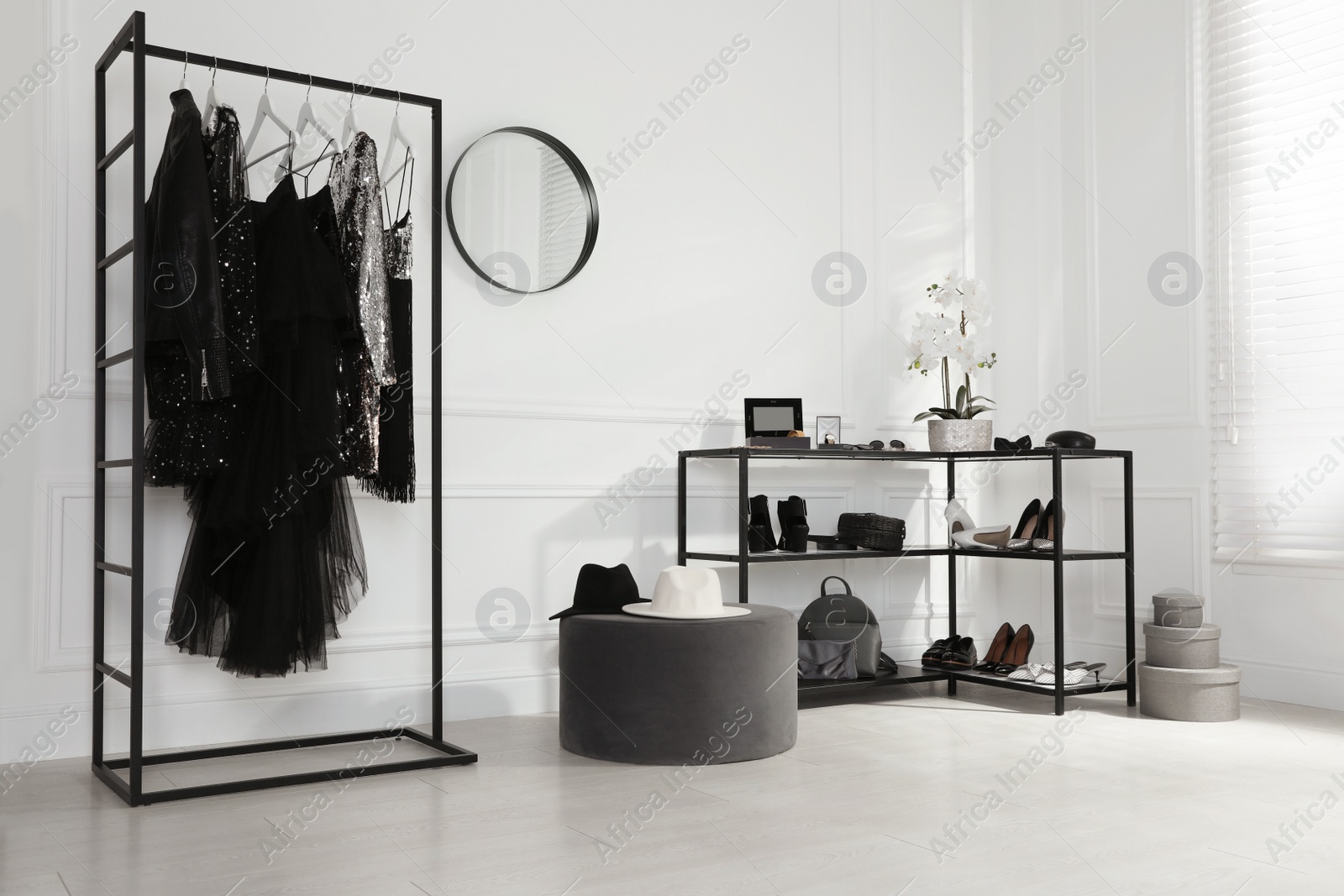 Photo of Stylish dressing room interior with trendy clothes, shoes and accessories