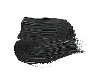 Photo of Brushstrokes of black oil paint on white background, top view