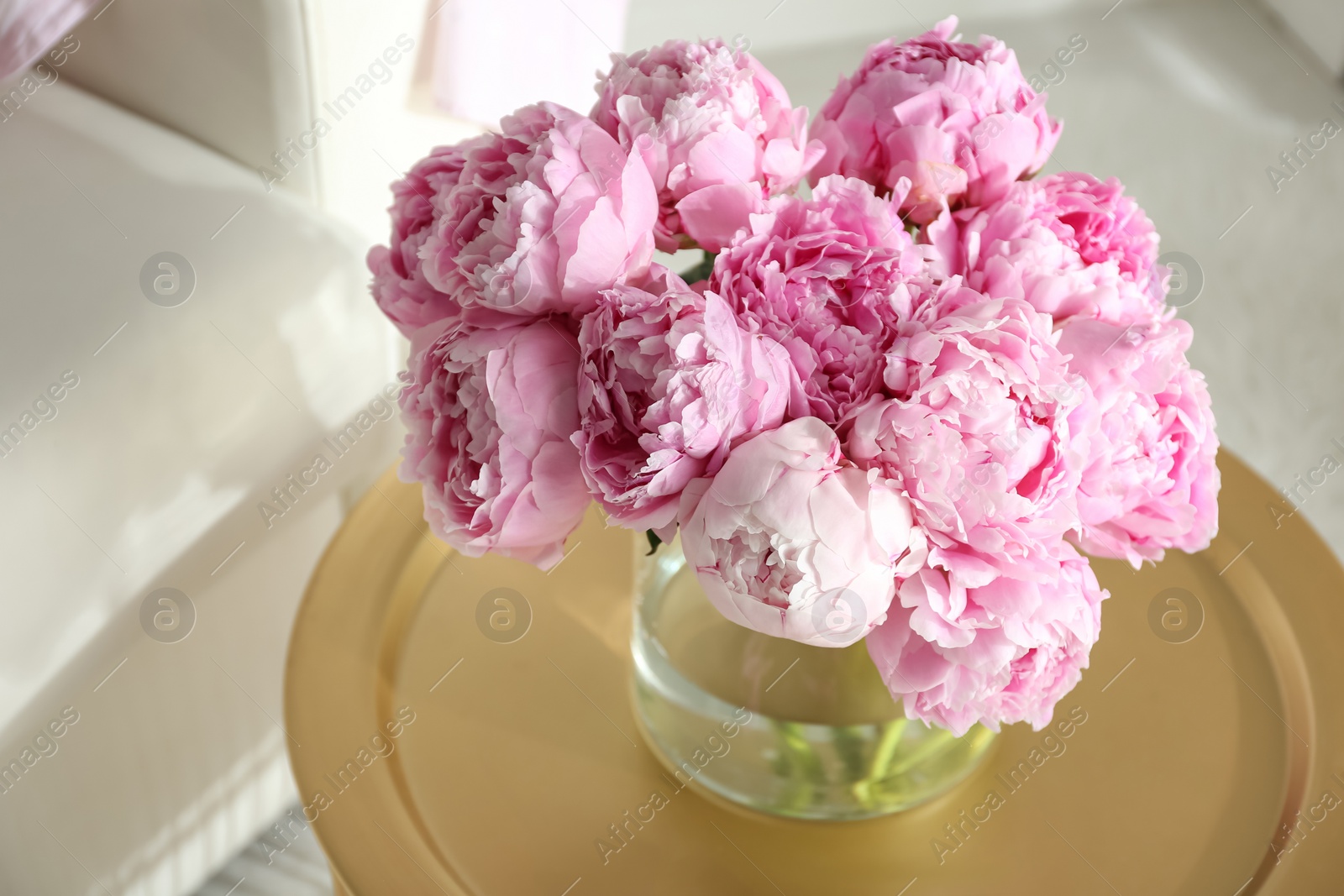 Photo of Bouquet of beautiful peonies on table indoors