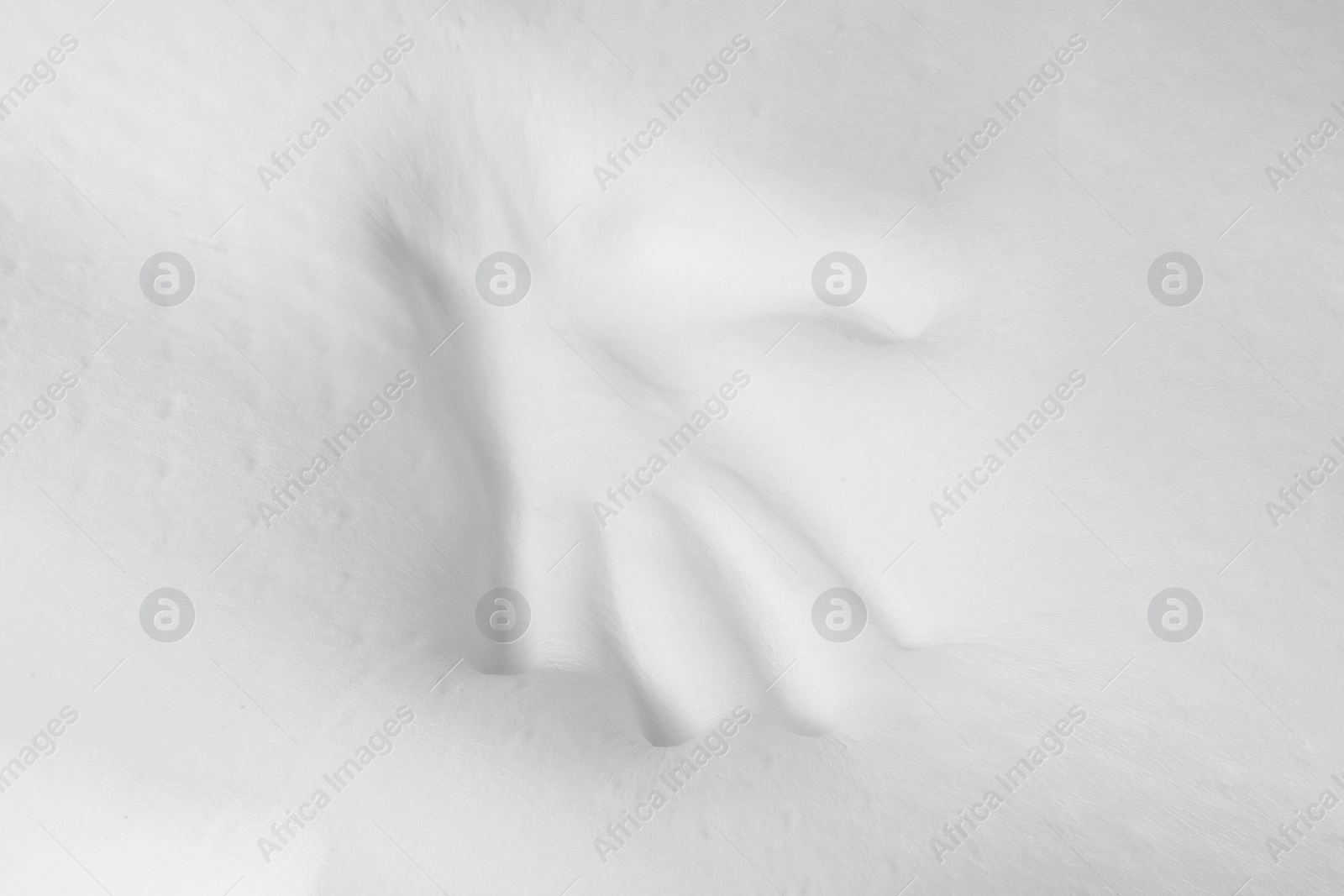 Photo of Memory foam pillow with handprint on white background, closeup