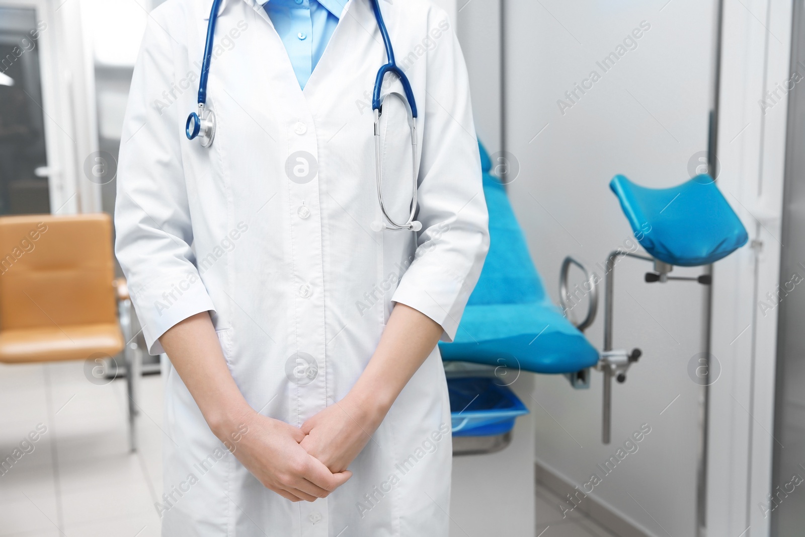 Photo of Young gynecologist in white coat at workplace, closeup