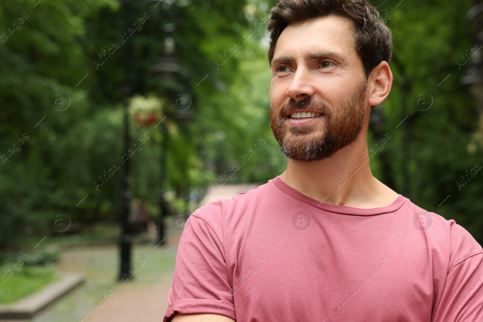 Photo of Portrait of handsome bearded man in park, space for text