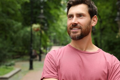 Photo of Portrait of handsome bearded man in park, space for text