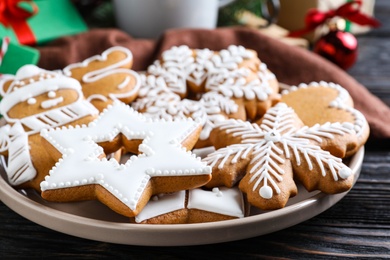 Photo of Delicious Christmas cookies on black wooden table table, closeup
