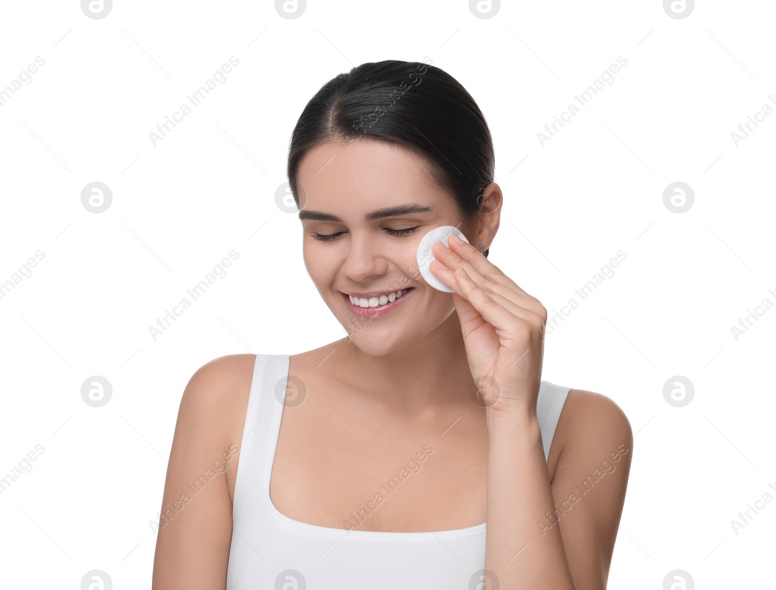 Photo of Young woman cleaning her face with cotton pad on white background