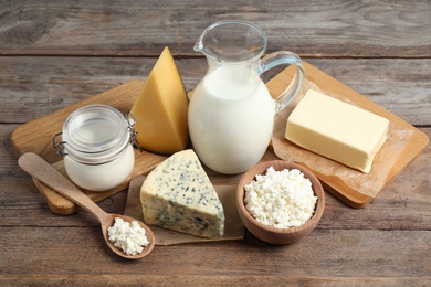 Different delicious dairy products on wooden table