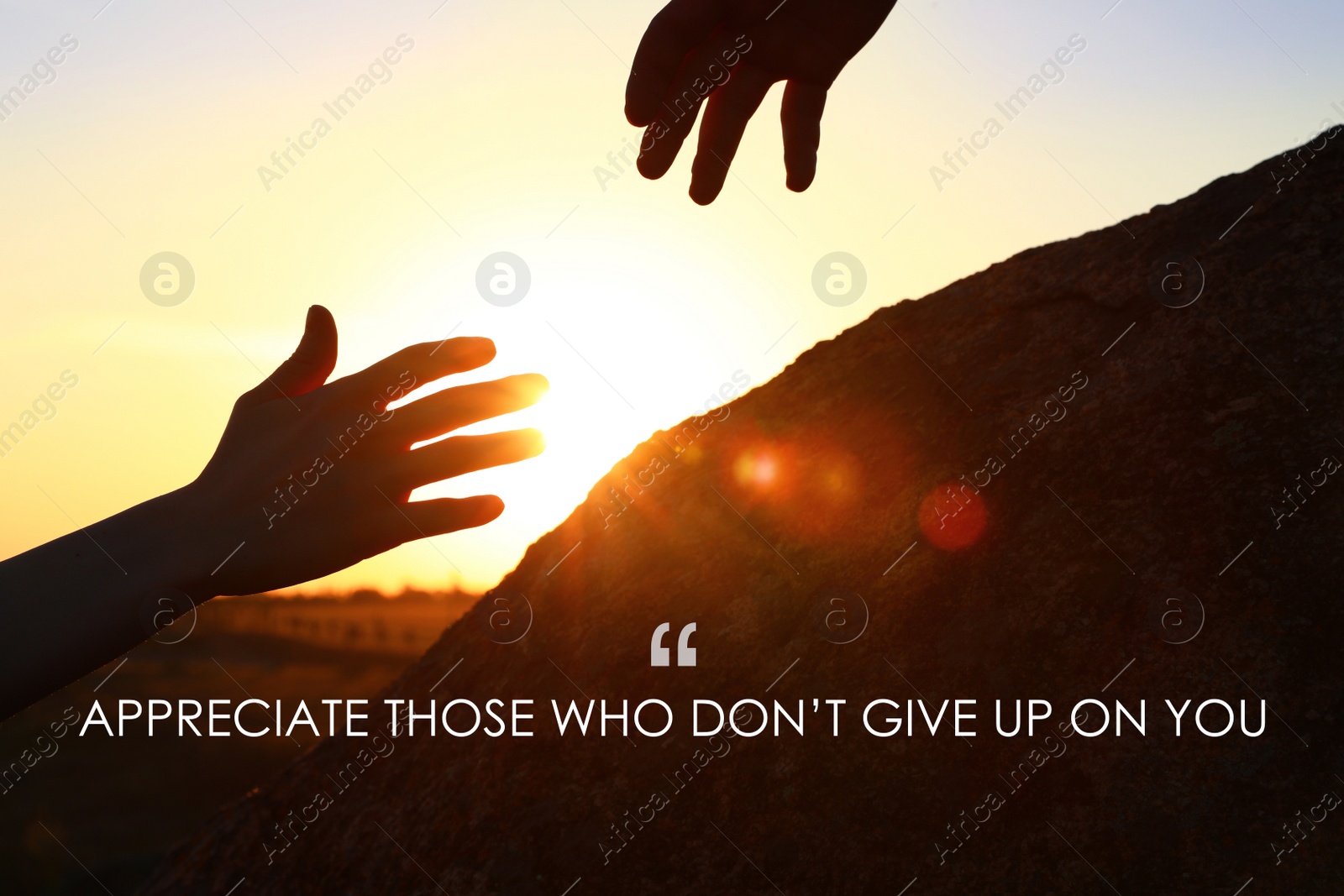 Image of Appreciate Those Who Don't Give Up On You. Inspirational quote reminding to be grateful for support from caring people. Text against view of hiker helping friend outdoors at sunset